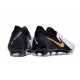 Bota Nike Phantom Luna II Elite L FG Blanco Negro Mtlc Dorado Moneda